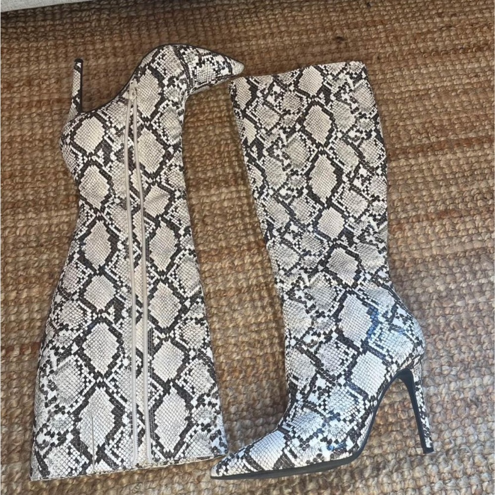 Knee high snake print boots. 3 inch heel. Worn once indoors for theme party.